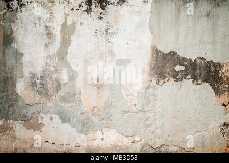 Full frame background of weathered, faded and dirty concrete wall with plaster peeled off with vignette Stock Photo