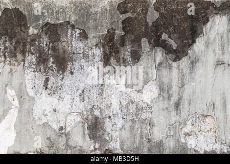 Full frame background of weathered, damaged and dirty concrete wall with plaster peeled off. Stock Photo