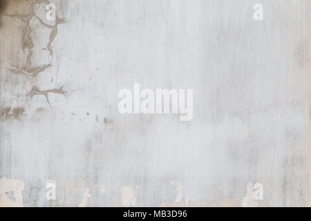 Weathered and aged light gray concrete wall with stains and paint partly peeled off Stock Photo