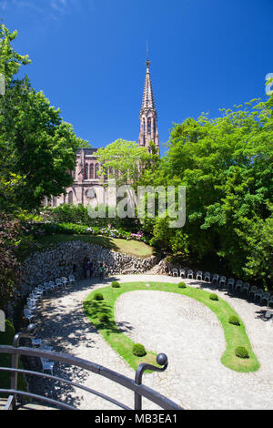 Comillas, Spain - July 3, 2017: View from palace of El Capricho or Villa Quijano by the architect Gaudi in modernist style with tourists in the villag Stock Photo