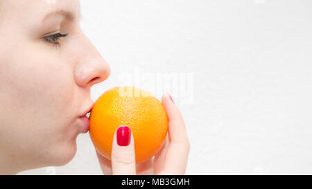 Girl loving healthy food, kissing an orange Stock Photo