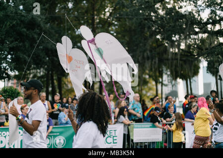 Pulse supporters march in Orlando Pride Parade with angels to remember and honor each of the victims in the Pulse shooting (2016). Stock Photo