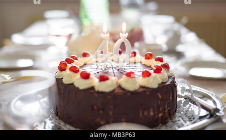 Happy 40th birthday cake with candles on table Stock Photo