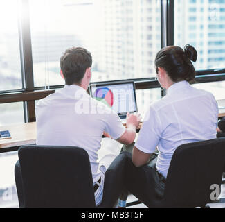 back view of young businessmen discussing project at meeting.Business presentation. Stock Photo