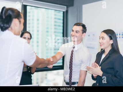 Business people shaking hands, finishing up a meeting in office city background Stock Photo