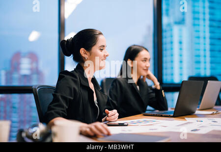 Young business woman working on laptop in the office Stock Photo