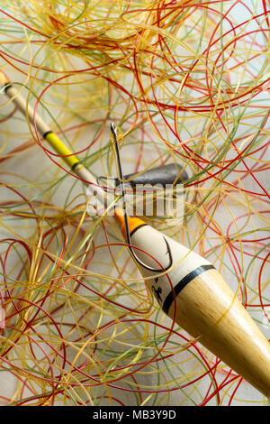 very tangled fishing line, hook in the foreground, all on white background  Stock Photo - Alamy