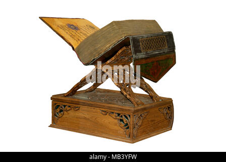 antique tattered Arabic book in leather binding on a carved wooden stand isolated Stock Photo