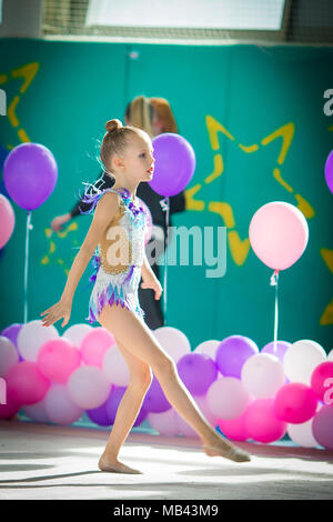 Adorable gymnast participates in competitions in rhythmic gymnastics Stock Photo