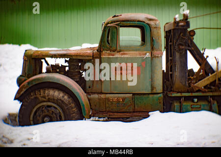 A 1942 White Super Power 2 1/2 ton winch truck on the side of a metal barn, in Noxon, Montana  This image was shot with an antique Petzval lens and wi Stock Photo