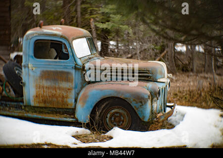 An old, blue 1946 Ford tow truck, on the side of a barn, in Noxon, Montana. Stock Photo