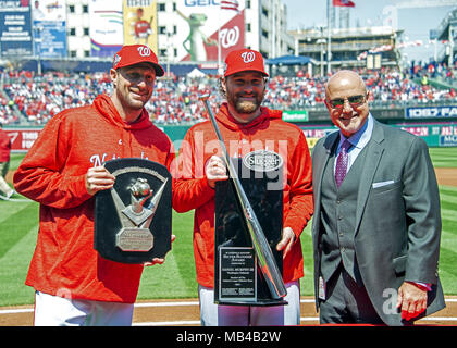 April 5, 2018 - Washington, District of Columbia, United States of America - Washington Nationals starting pitcher Max Scherzer (31), left, holds the 2017 Cy Young Award; Washington Nationals second baseman Daniel Murphy (20), center, holds his 2017 Silver Slugger award, as they pose for a photo with Mike Rizzo, general manager and president of baseball operations of the Washington Nationals, prior to the game against the New York Mets at Nationals Park in Washington, DC on Thursday, April 5, 2018. The Mets won the game 8-2.Credit: Ron Sachs/CNP. (Credit Image: © Ron Sachs/CNP via ZUMA W Stock Photo