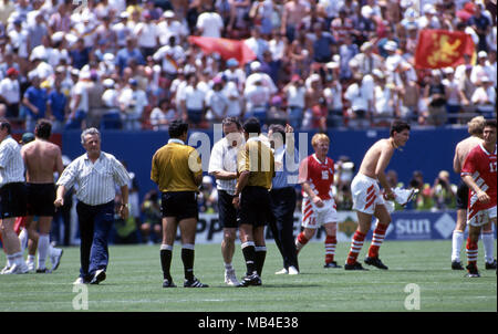 FIFA World Cup - USA 1994 10.7.1994, Giants Stadium, New York/New Jersey. World Cup Quarter Final, Bulgaria v Germany. Coach Dimitar Penev shakes hands with the referees as Bulgarians celebrate a surprise victory. Stock Photo