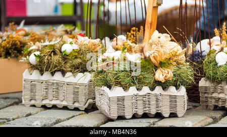 Traditional Easter decorative symbols made from natural materials, rabbit, chickens, hen, straw, eggs, Easter street market. Stock Photo