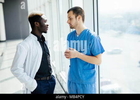 Two doctors discussing results of the analysis in hospital Stock Photo