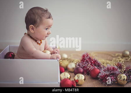 6 Month Old Baby In A Box With Christmas Decorations Stock Photo - Alamy