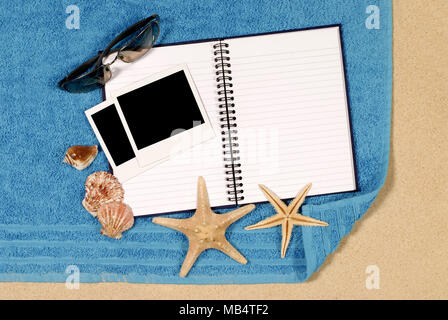 Beach scene with blank writing book and polaroid photo prints Stock Photo