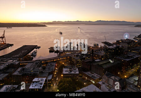 WASHINGTON - Ferries on Elliott Bay and Colman Dock after sunset over the Olympic Mtns from the Observation Deck on Seattle's Smith Tower. 2017 Stock Photo