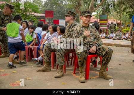 U.S. Navy Lt. Aroon Seeda plays musical chairs with students and service members during Exercise Cobra Gold 2018 at Pong Ka Sang School in Nakhon Ratchasima, Kingdom of Thailand, Feb. 20, 2018. Chaplain Seeda was Born and raised in Pluak Daeng, Rayong province, Kingdom of Thailand as a Buddhist monk and immigrated to the United States in 2001 before joining the Navy Reserve in 2008. Humanitarian civic assistance projects conducted during the exercise support the needs and humanitarian interests of the Thai people. Cobra Gold 18 is an annual exercise conducted in the Kingdom of Thailand and run Stock Photo