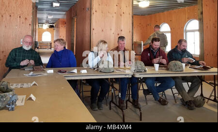 Members of the Killeen and Harker Heights Chambers of Commerce eat Meals Ready-to-Eat in the mock governor’s mansion located in the fictitious town of Razish at the National Training Center, Fort Irwin, Calif., Feb. 18, 2018. The Killeen and Harker Heights Chambers of Commerce NTC visit is designed to strengthen relationships between civic leaders in the surrounding Fort Hood community and service members assigned to Fort Hood, Texas. Stock Photo