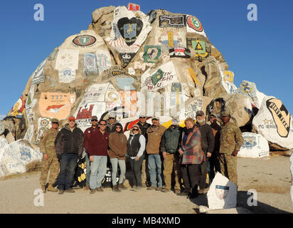 III Corps leadership and members of the Harker Heights Chambers of Commerce pose for a group photo in front of the Painted Rocks monument at Fort Irwin, Calif., Feb. 18, 2018. Each unit that completes a training rotation at the National Training Center paints a rock with their unit symbol to commemorate their time in “The Box.” From left to right: Maj. Gen. John Thomson III, deputy commanding general of operations, III Corps; Keith Sledd, executive director for Heart of Texas Defense Alliance; Ryan Shahan, city president of National United; Glenn Hegar, comptroller of Texas; John Crutchfield I Stock Photo