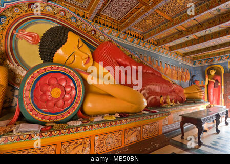 Horizontal view of the reclining Buddha at Isurumuniya Rock Temple in Anuradhapura, Sri Lanka. Stock Photo
