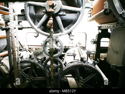 Old run down industrial plant machinery with cogs and gear wheels Stock Photo