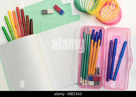 A pencil case, pens, pencils, notebook, notebooks lie on the table. Stationery school accessories. Stock Photo
