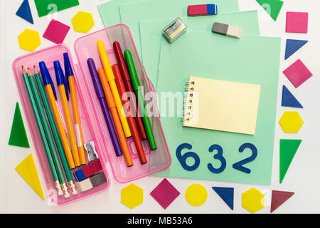 A pencil case, pens, pencils, notebook, notebooks lie on the table. Stationery school accessories. Stock Photo