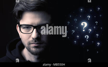businessman with many question mark near him Stock Photo
