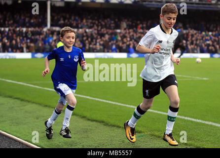 Football fans James and Daniel, who are raising money for Prostate Cancer UK and the British Heart Foundation for their grandads, run around the pitch at half-time of the Premier League match at Goodison Park, Liverpool. Stock Photo