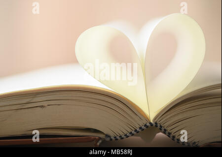 Book page in heart shape on vintage tone Stock Photo