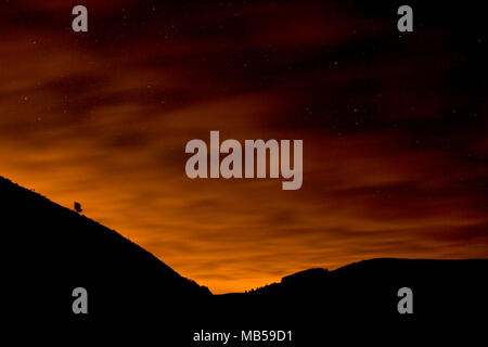 Clouds and stars at night over the Clwydian Range, North Wales Stock Photo
