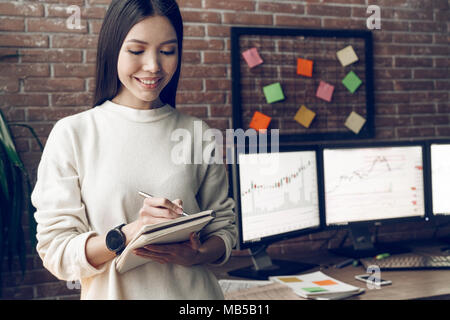 Handsome analyst, trader, marketer or advertiser working in the office. Indoor, studio shot. Business people concept, work in office Stock Photo