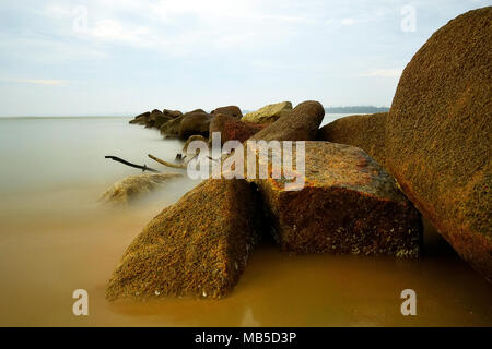 Rocks and ocean water flowing over them taken with slow shutter speed Stock Photo