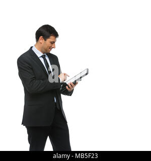 handsome young businessman in business sut, blue shirt and tie holding tablet in leather case. happy expression. man greeting someone. studio shot iso Stock Photo