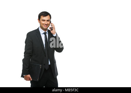 handsome young businessman in business sut, blue shirt and tie holding tablet in leather case. happy expression. man greeting someone. studio shot iso Stock Photo