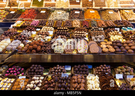 Chocolate, sweets, nuts and dried fruit stall at La Boqueria Market in Barcelona, Spain Stock Photo