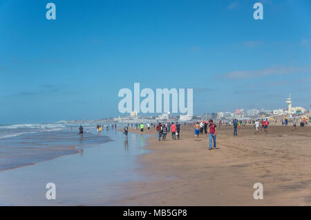 Casablanca Morocco - May 7, 2017 - People enjoy swimming, walking and playing football in the sea at Ain Diab beach Stock Photo