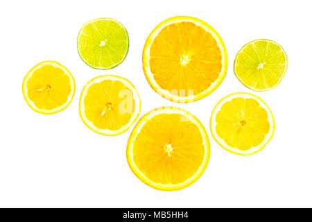Thin slices of lemon, lime and orange arranged in a high-key citrus fruit still life Stock Photo