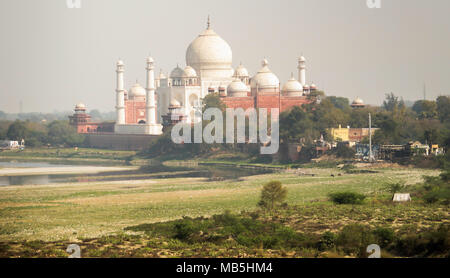 View of the Taj Mahal through the haze from Agra Fort. The Agra fort is a UNESCO World Heritage site. Stock Photo