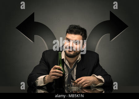 Drunk disappointed man sitting at table with arrows around  Stock Photo