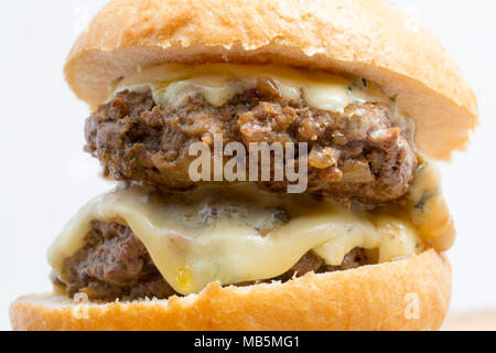 A double wild boar burger made from a wild boar shot in Tuscany Italy with melted Cambozola cheese. Stock Photo