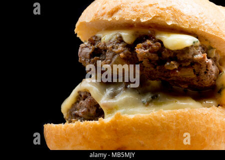 A double wild boar burger made from a boar shot in Tuscany Italy, with melted Cambozola cheese. Stock Photo