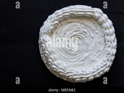 Meringue unfilled on black background - Large meringue top view photo Stock Photo
