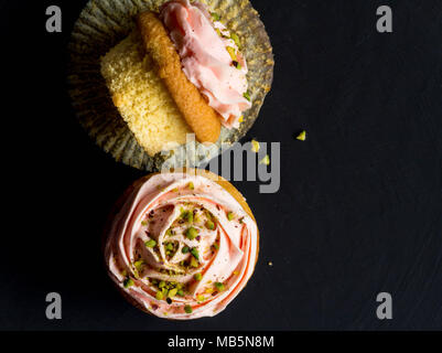 Cup cakes top view photo on black background. Stock Photo