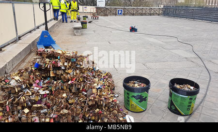 Paris, France -  03 April 2018. Workmen remove Padlocks on the bridge at Pont Neuf on 03 April 2018.  The first Iron bridge built in France, had its railings replaced with glass panels after they collapsed under the weight on the metal padlocks and this culture has cropped up in other bridges in Paris. General view of Paris, France. @ David Mbiyu/Alamy Live News Stock Photo