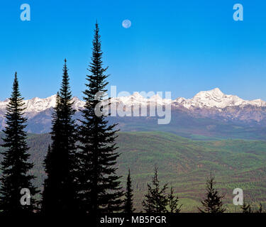 moon setting over the mission mountains near condon, montana Stock Photo