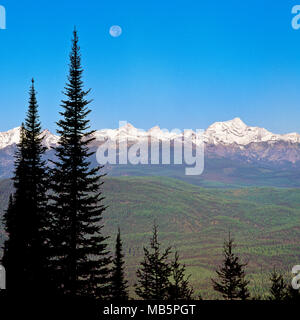 moon setting over the mission mountains near condon, montana Stock Photo