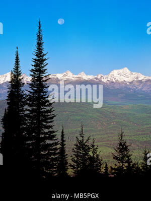 moon setting over the mission mountains near condon, montana Stock Photo